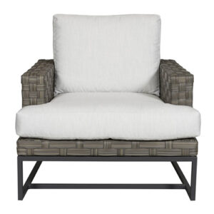 Modern woven rattan lounge chair with white cushions.