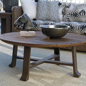 Wooden coffee table with decorative bowl and sculpture.