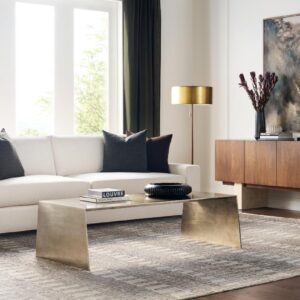 Modern living room with white sofa and gold accents.